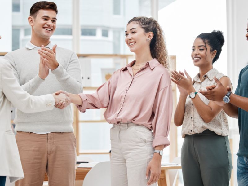 Team celebrating successful new hire — recruitment agency connecting employers with top talent