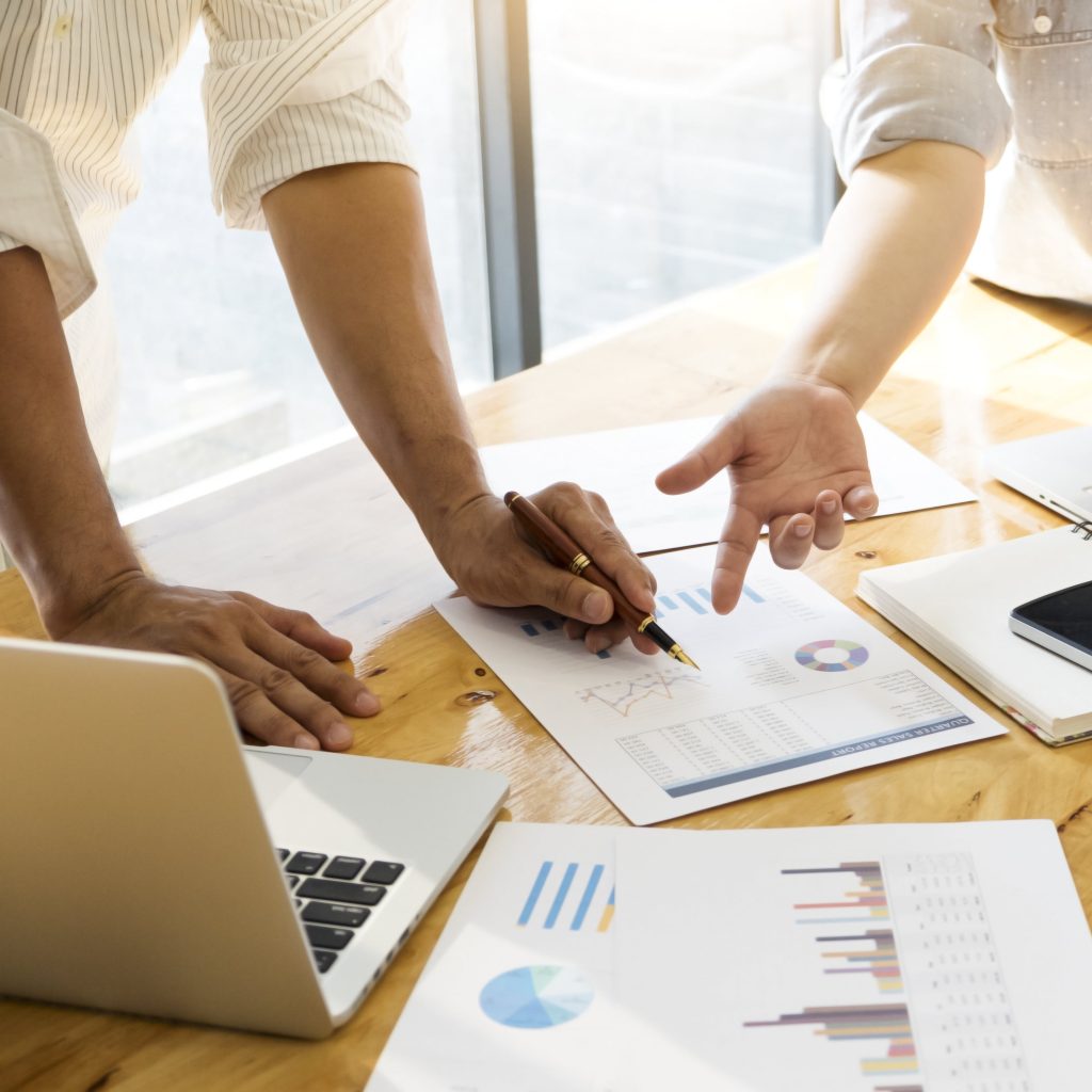 Employers reviewing recruitment reports and staffing strategies during team meeting