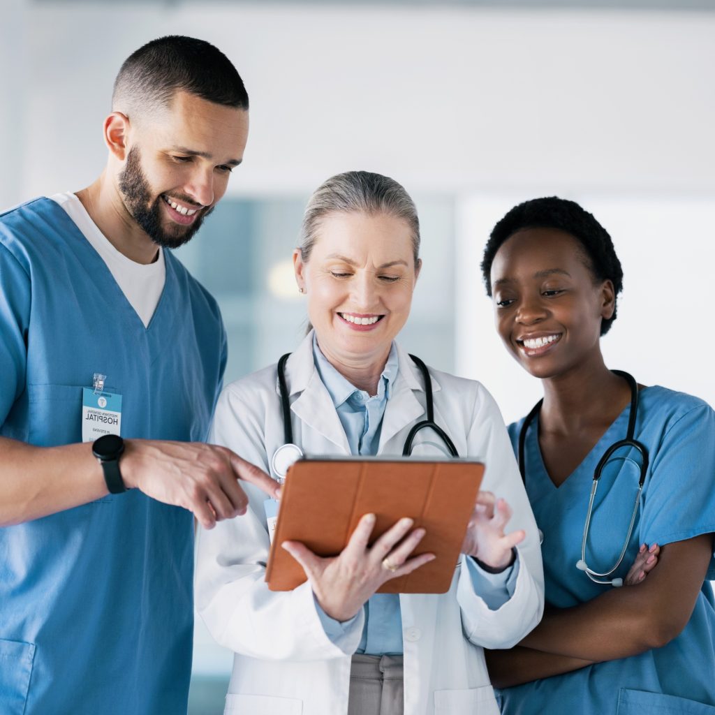 Healthcare professionals reviewing patient data on tablet — medical staffing and recruitment services for hospitals